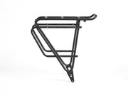 Left-side profile view of the Trek BackRack Deluxe MIK Studs Rear Rack, showing the support struts, cargo platform, and pannier-compatible side rails.