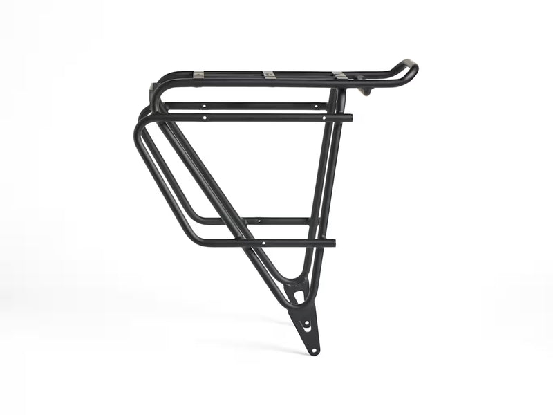 Left-side profile view of the Trek BackRack Deluxe MIK Studs Rear Rack, showing the support struts, cargo platform, and pannier-compatible side rails.