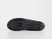 Bottom profile view of black Trek Circuit Wide shoe showing nylon composite sole with molded Trek logo, traction treads, and universal 3-bolt road and 2-bolt SPD cleat mounting zone