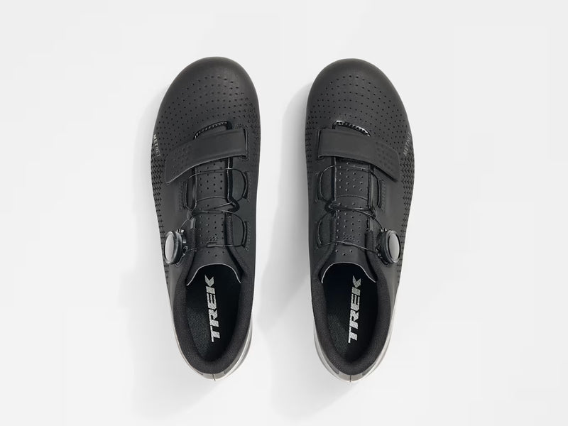 Top-down overhead view of paired black Trek Circuit Wide shoes showing instep strap layout, lateral BOA dials, triangular upper perforations, and branded footbed