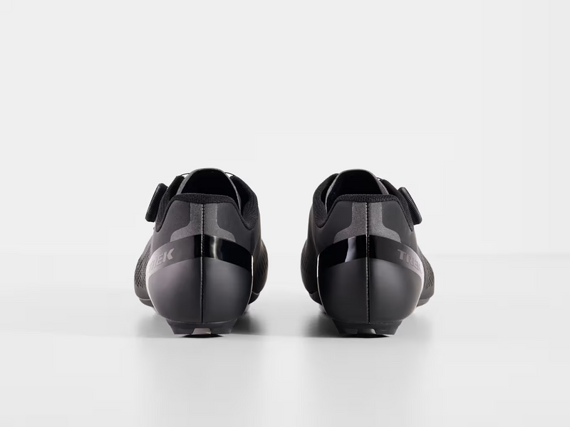 Rear view of paired black Trek Circuit Wide shoes highlighting structured heel counters, padded ankle collars, and wider rear profile