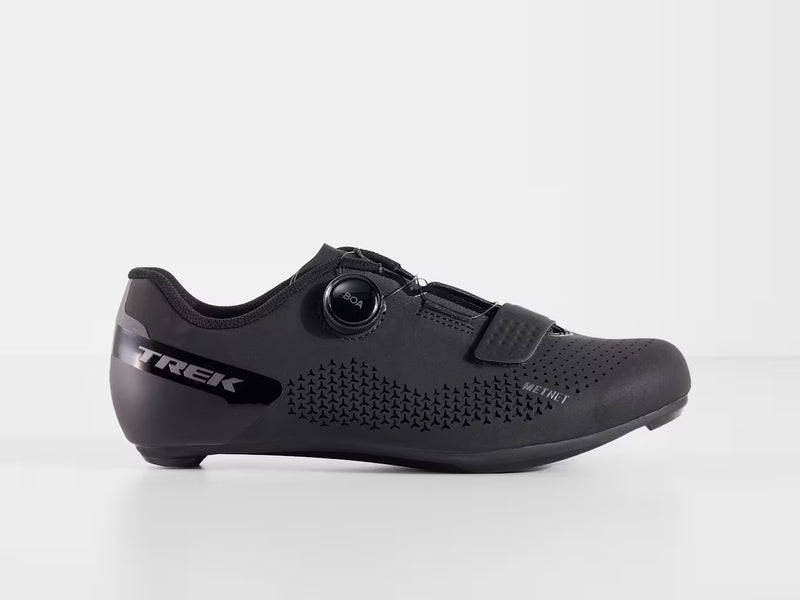 Lateral side view of black Trek Circuit Wide road cycling shoe featuring BOA L6 dial closure, forefoot hook-and-loop strap, triangular patterned ventilation perforations, and Trek branding