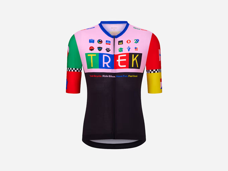 Trek First 50 Cycling Jersey (Limited Edition), front view in bold pink, black, green, and red with block TREK letters