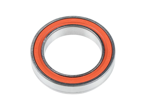 A close-up studio shot of a metal bearing with a bright orange inner ring, isolated on a white background.