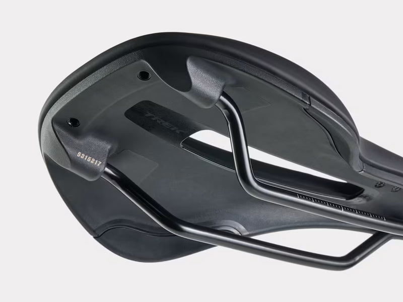 Close-up of a black bicycle saddle on a light gray background