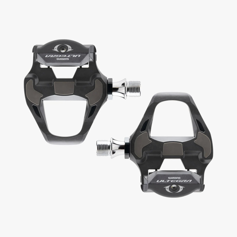Two black Shimano Ultegra bicycle pedals on a white background