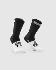 A pair of black and white climbing socks with gray accents, displayed on a light gray background. One sock shows the text 'CLIMB EDDY 1/3' in black on a white toe, and the other shows a large black 'G' logo with 'G-LOC' underneath.