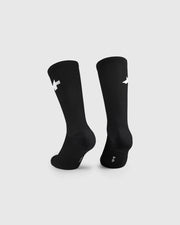Black socks with white logo on a light gray background