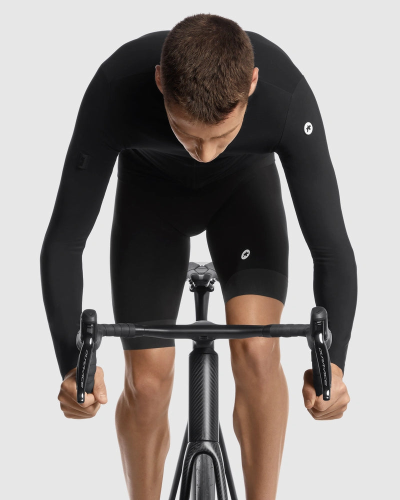 Person wearing a black cycling suit on a white background