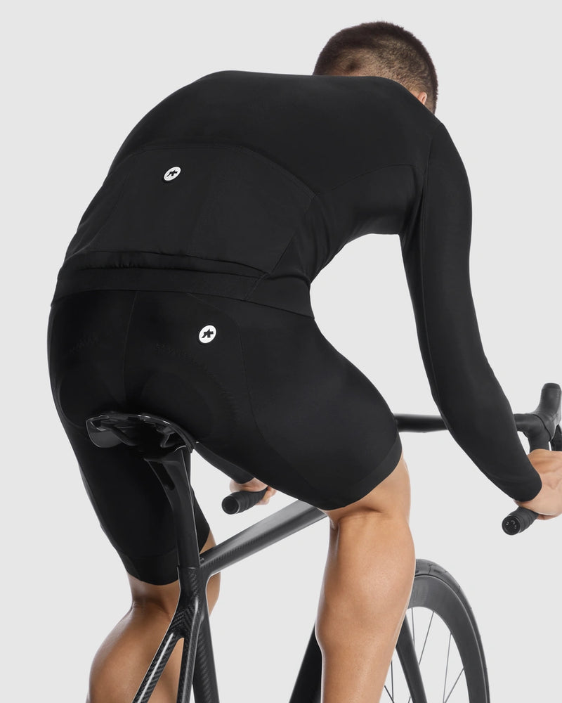 Person wearing a black cycling outfit on a white background
