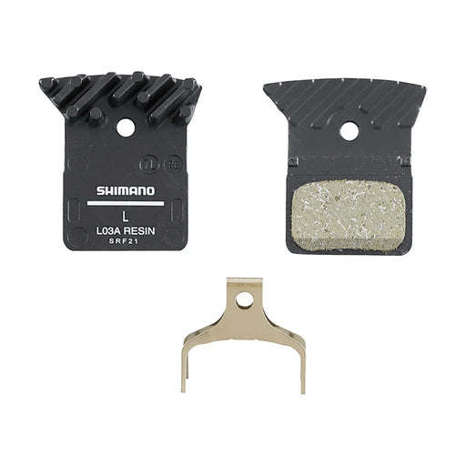 Shimano brake pad set with metallic and black components on a white background