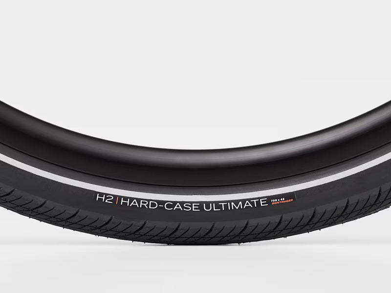 Close-up of a black bicycle tire with 'H2 Hard-Case Ultimate' branding on a white background
