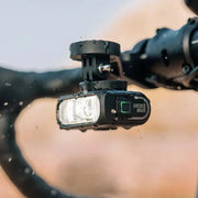 lifestryle image of closeup of bike handlebar with hori 900 light in snowy weather