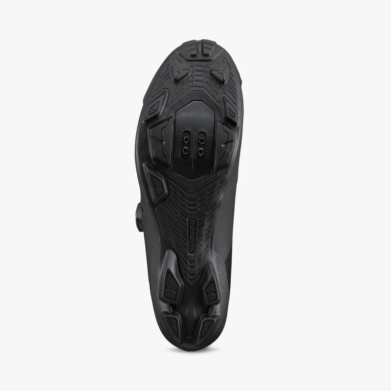 Shimano SH-XC302 cycling shoe in black, sole view with rubber tread and cleat area