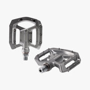 Two Shimano bicycle pedals on a white background