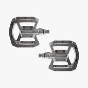 Pair of gray bicycle pedals on a white background