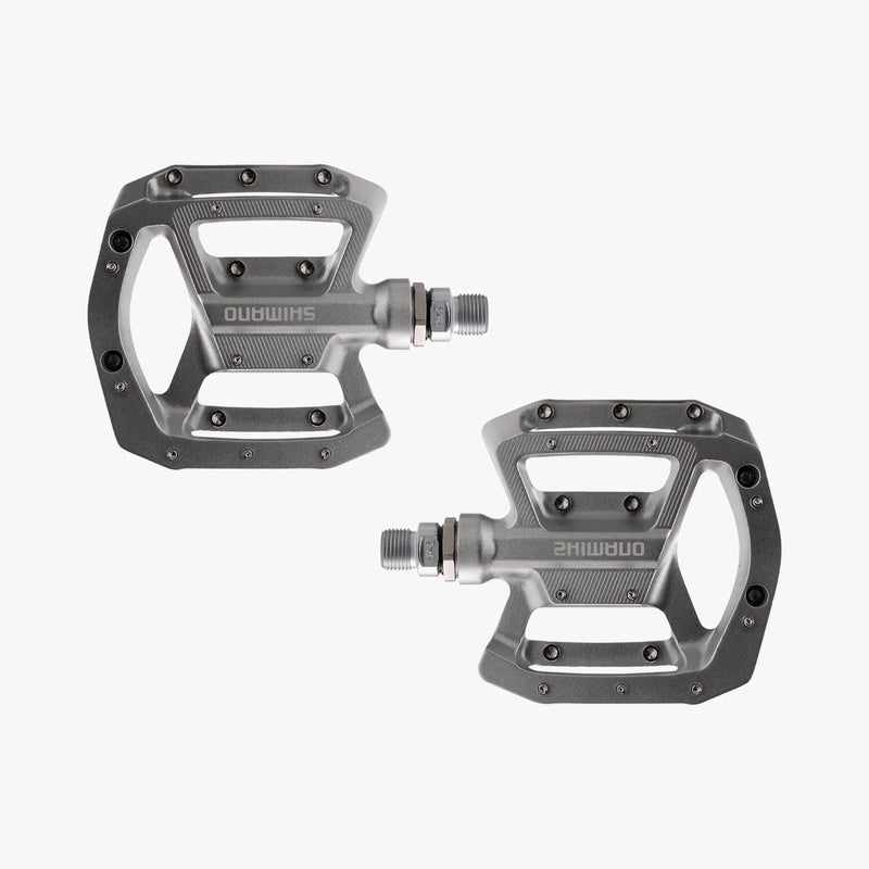 Pair of gray bicycle pedals on a white background
