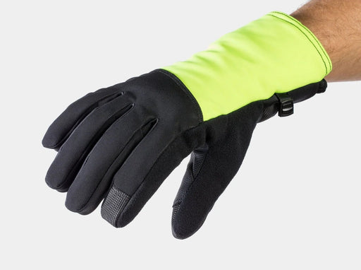 A high-visibility neon yellow-green and black work glove shown on a person's hand against a light gray background.
